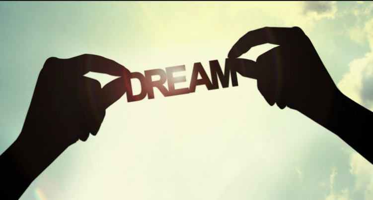To hands holding up the word DREAM